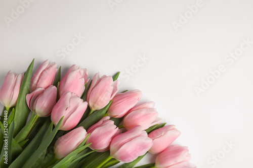 Fototapeta Naklejka Na Ścianę i Meble -  Beautiful pink spring tulips on white background, top view