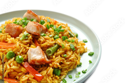 Delicious rice pilaf with chicken and vegetables on white background, closeup