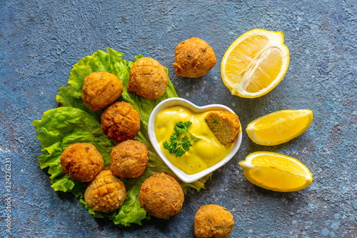 Deep-fried homemade vegetarian falafel made from ground chickpeas and broccoli, with mustard lemon sauce