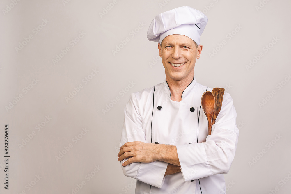 Smiling senior male chef isolated over white background. Smiling senior male chef isolated over white background.