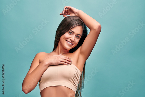 Beautiful young woman on blue background. Epilation,cosmetology, beauty and spa concept. photo