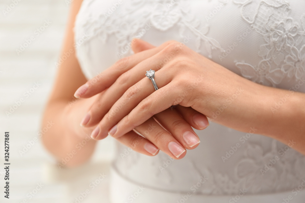 Young bride wearing beautiful engagement ring, closeup Young bride wearing beautiful engagement ring, closeup
