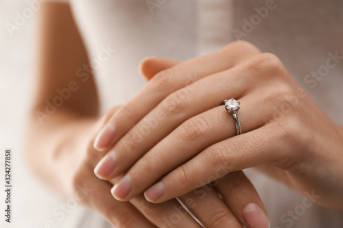 Young bride wearing beautiful engagement ring  closeup