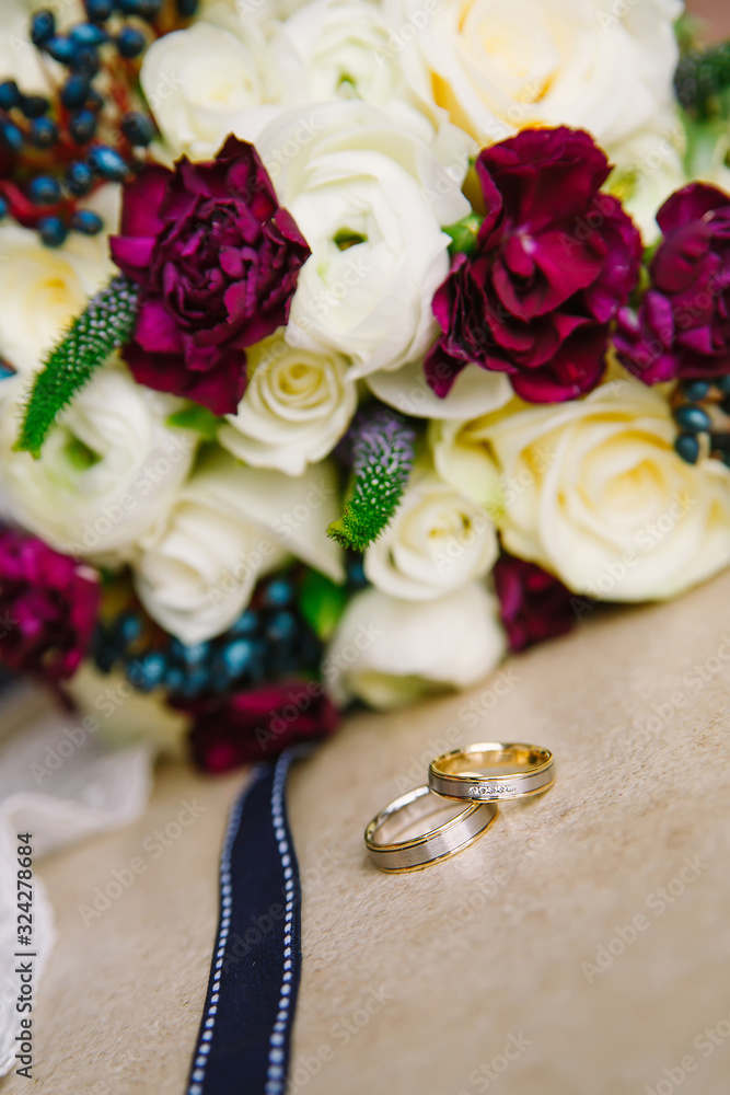 Wedding rings on a background of a bouquet of flowers Wedding rings on a background of a bouquet of flowers