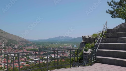 The Beautiful Scenery Of The Entire City From The Open Amphitheater In Crkvina Hill Under The Bright Blue Sky - wide shot photo
