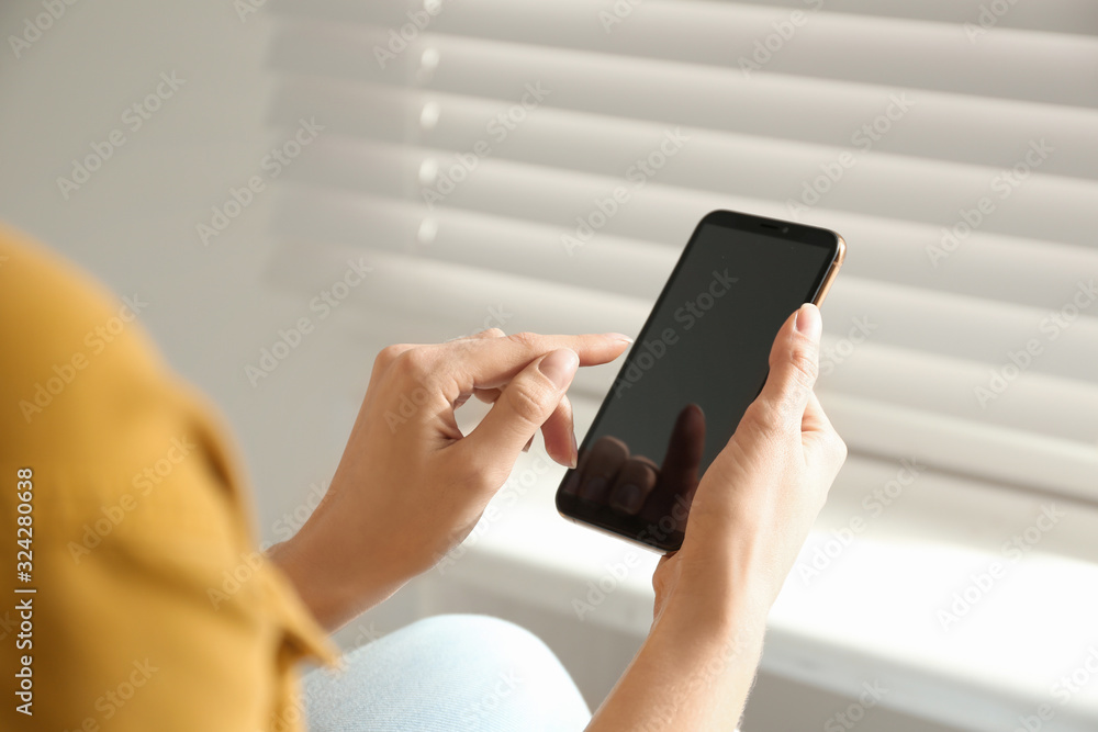 Young woman using modern smartphone indoors, closeup Young woman using modern smartphone indoors, closeup