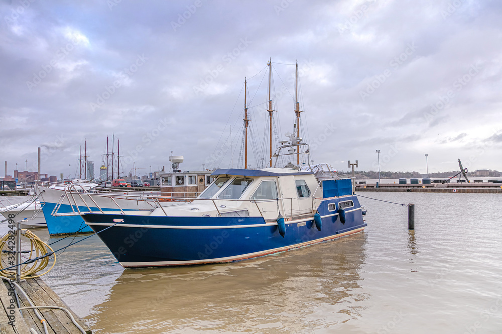 Fototapeta premium Yachts on the pier. Helsinki embankment, Finland. - February 19, 2020: Cloudy Day