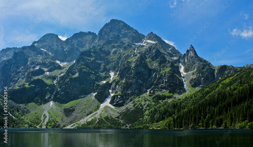 The lake Morskie Oko or Eye of the Sea. Western Carpathian mountains. The Tatra National Park in the Rybi Potok (the Fish Brook) Valley, Zakopane, Poland. The lake Morskie Oko or Eye of the Sea. Western Carpathian mountains. The Tatra National Park in the Rybi Potok (the Fish Brook) Valley, Zakopane, Poland.