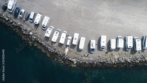 Фотография Top view of area with campers, caravans in parking near ocean