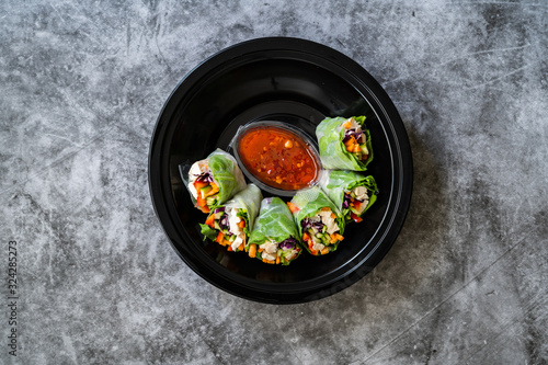 Take Away Healthy Asian Vietnamese Spring Roll / Goicuon with Rice Paper Rolls and Red Hot Chili Sauce in Plastic Container Plate Package or Box.