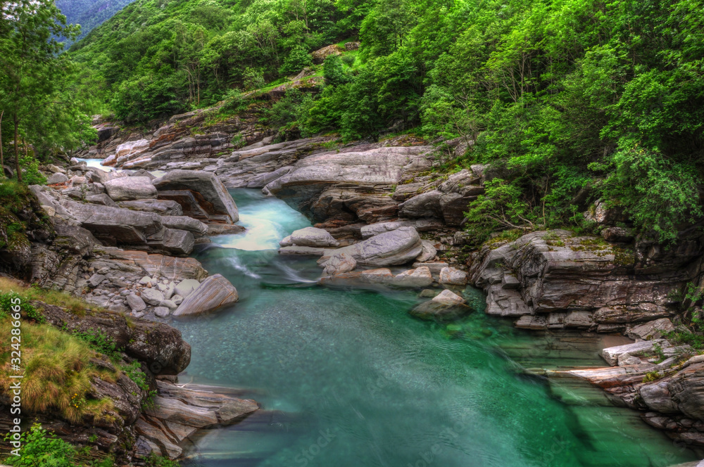 River and Rocks in Long Exposure in Valley Verzasca in Ticino, Switzerland. River and Rocks in Long Exposure in Valley Verzasca in Ticino, Switzerland.