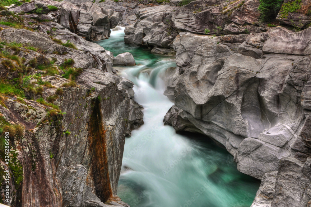 Obraz premium River and Rocks in Long Exposure in Valley Verzasca in Ticino, Switzerland.
