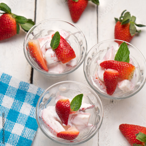 Strawberries and cream dessert on white background