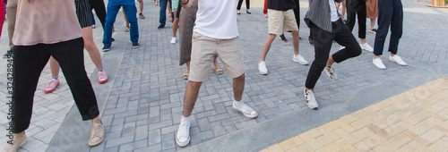Social dance and flashmob concept - Fun and dance with in the summer on a city street. Close-up of dancers feet.