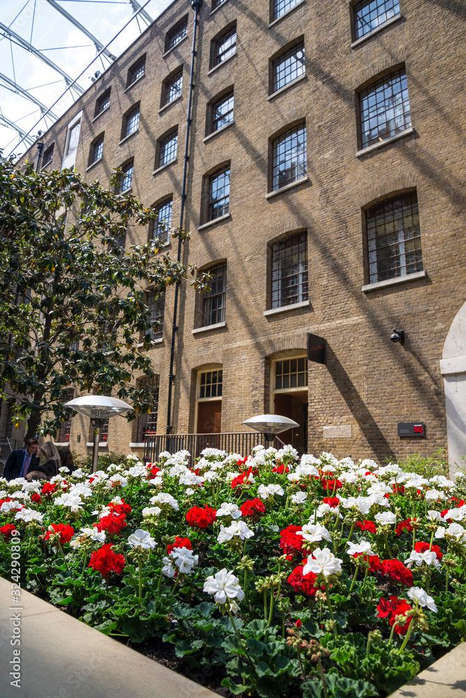 Flowerbed of white and red carnation flowers, Devonshire Square SQ, City of London, UK