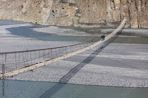 Hussaini suspension bridge passu cones mountain range rocky scenery huzza river gilt baltistan northern areas Pakistan photo