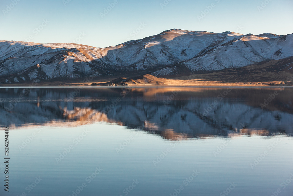 Obraz premium Mirror reflection in calm lake. morning light. Western Mongolia