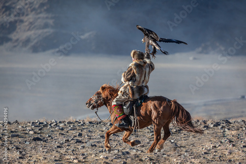 Kazakh berkut hunting western Mongolia Golden eagle festival horse riding photo