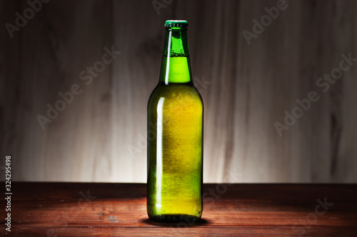 green bottle of beer on the background of panels