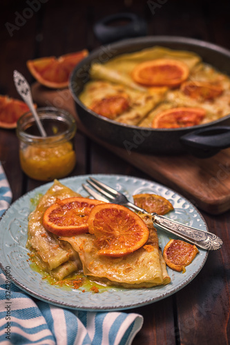 Sweet thin French crepes Suzette with orange sauce for a delicious breakfast