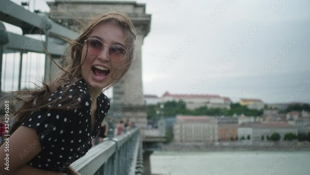 woman is shouting jokingly on bridge in Budapest woman is shouting jokingly on bridge in Budapest
