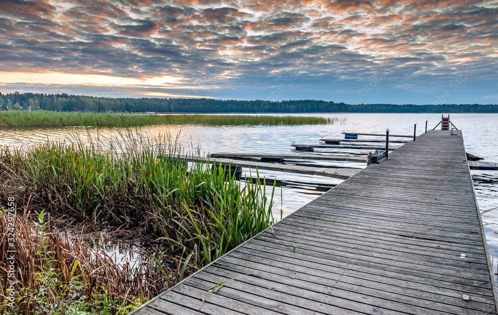 Fototapeta premium Wooden pier and walkway to the beach of the lake, morning, Europe