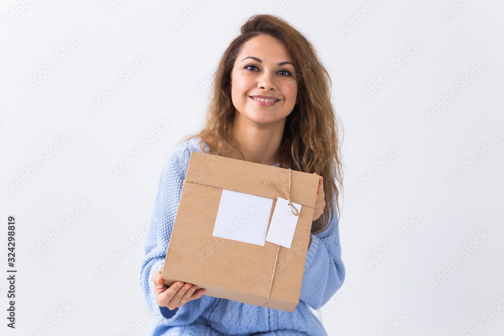 Online shopping, delivery and fashion concept - Woman sitting on sofa at home holds online clothing purchase Online shopping, delivery and fashion concept - Woman sitting on sofa at home holds online clothing purchase