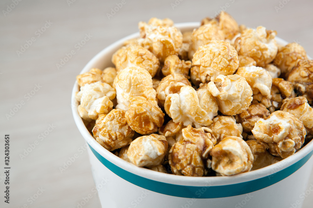 big cardboard cup with golden sugar popcorn big cardboard cup with golden sugar popcorn