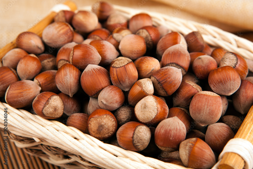 whole hazelnut kernels in a wicker basket still life whole hazelnut kernels in a wicker basket still life