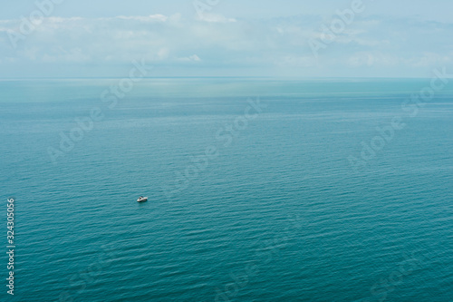 Blue sea waves soft surface with ship.