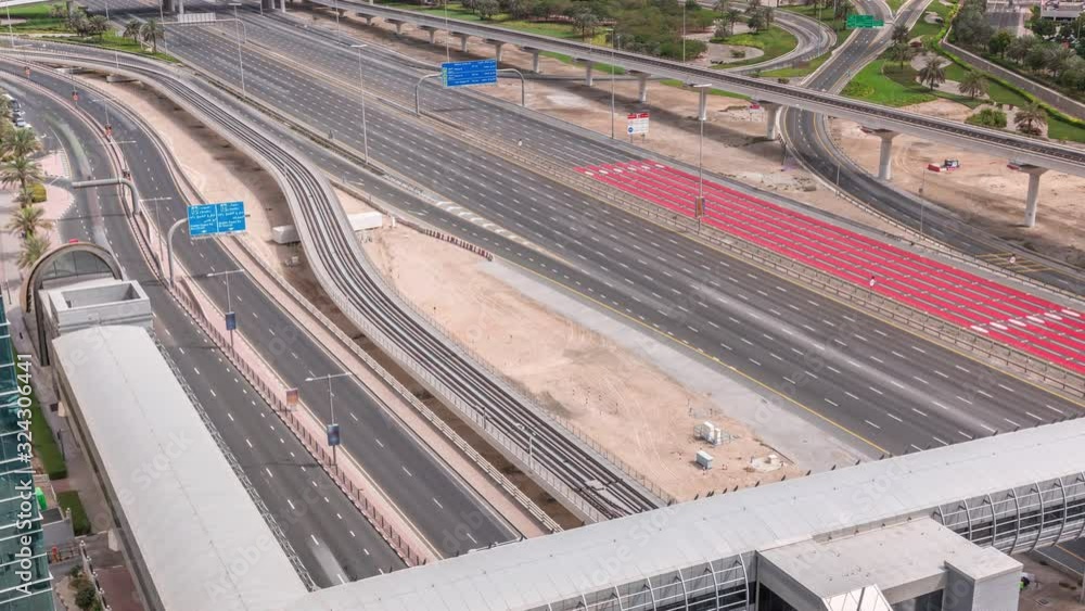 Aerial top view to Sheikh Zayed road with footbridge near Dubai Marina and JLT morning timelapse, Dubai. Traffic, bridges and metro line. United Arab Emirates Aerial top view to Sheikh Zayed road with footbridge near Dubai Marina and JLT morning timelapse, Dubai. Traffic, bridges and metro line. United Arab Emirates