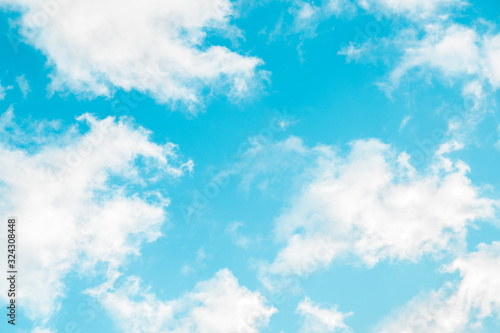 spring blue sky with fluffy clouds moved by the wind