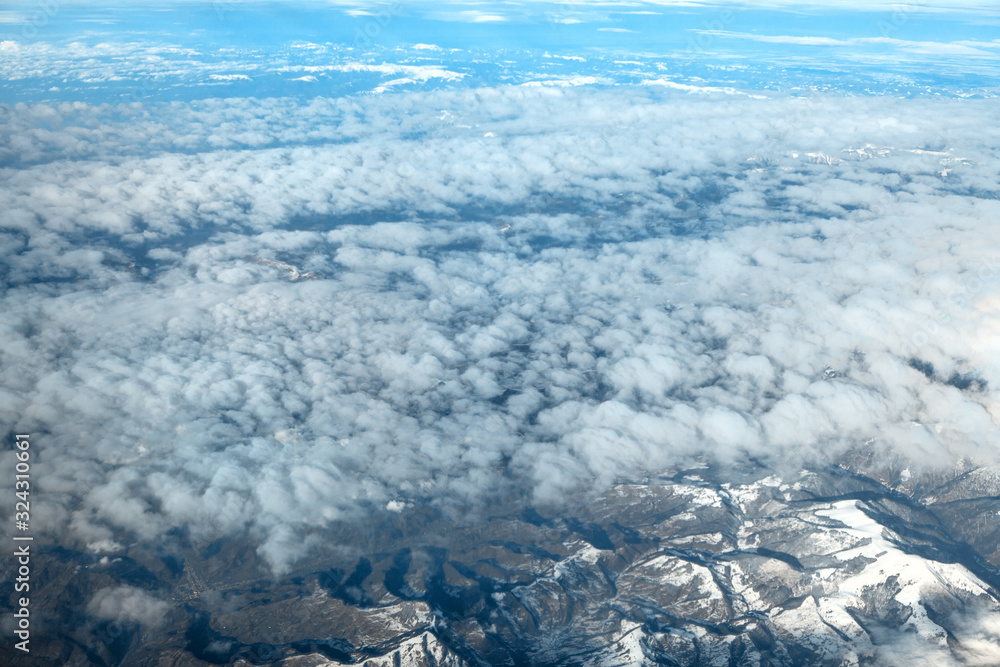 Obraz premium view of clouds and Alps mountains covered with snow