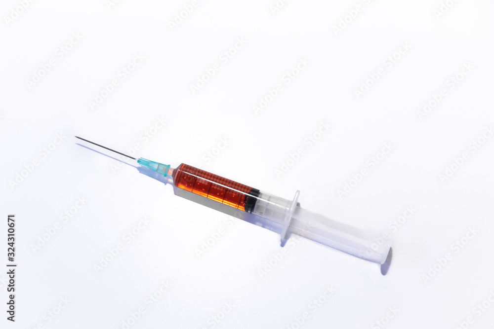 Fototapeta premium syringe and needle with orange vaccine