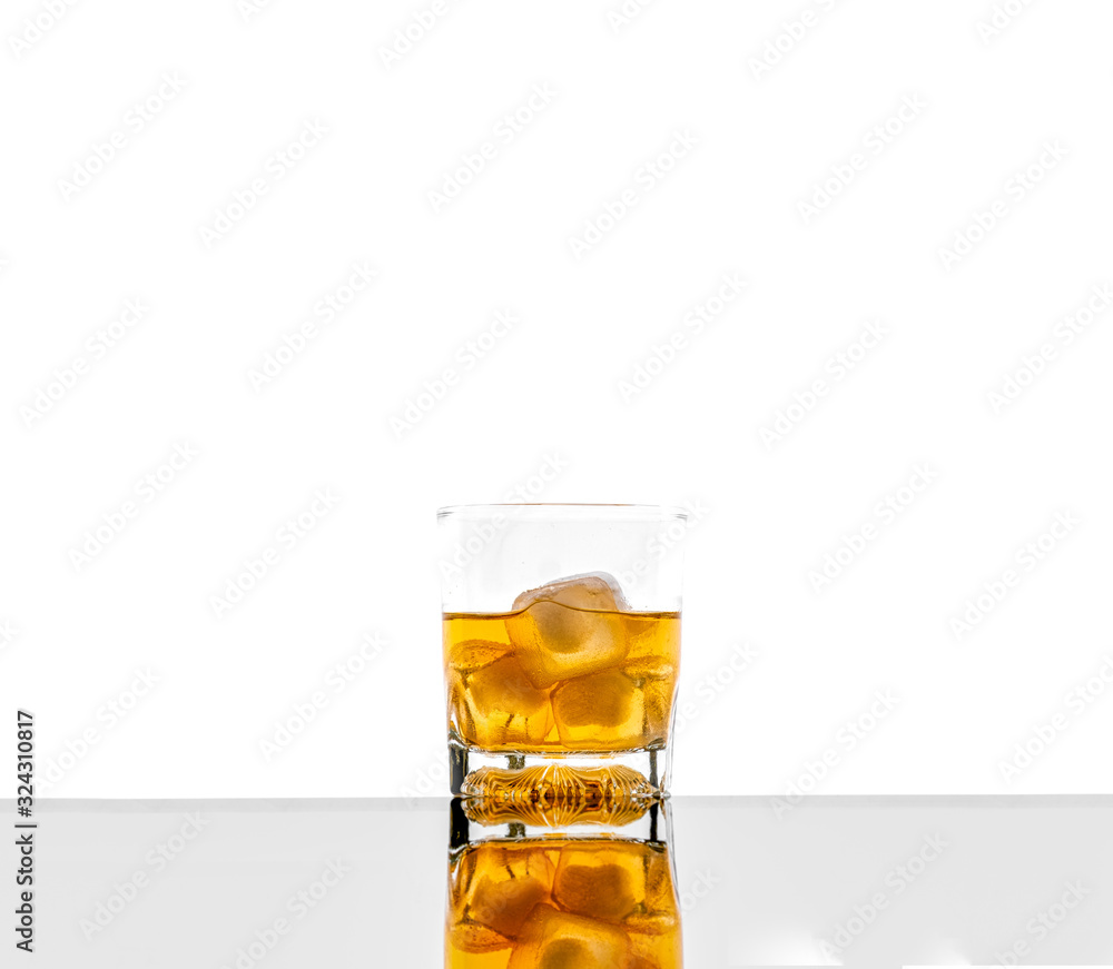 Glass with alcoholic drink with ice, on the rocks, whisky, rum, cognac, brandy, scottish, white background Glass with alcoholic drink with ice, on the rocks, whisky, rum, cognac, brandy, scottish, white background