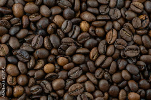 brown roasted coffee beans in the whole photo background