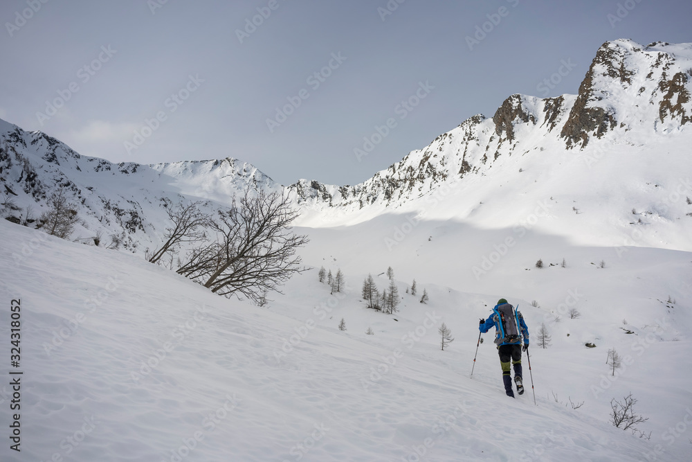 Man on an excursion in snowy mountains, Lombardy, Valtellina, Italy Man on an excursion in snowy mountains, Lombardy, Valtellina, Italy