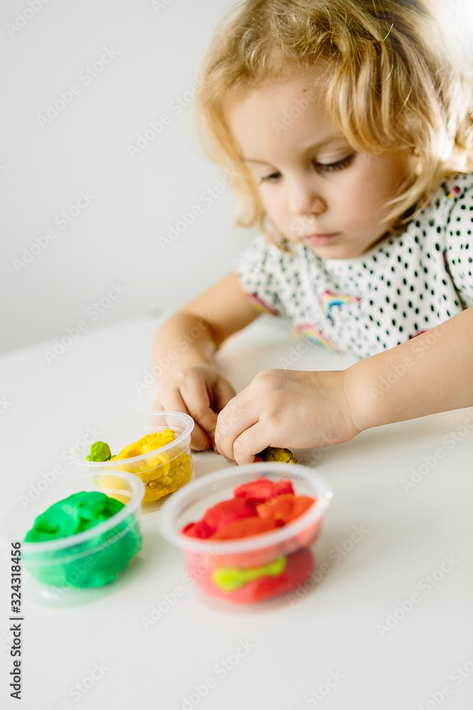 the child is engaged in modeling on the table the child is engaged in modeling on the table