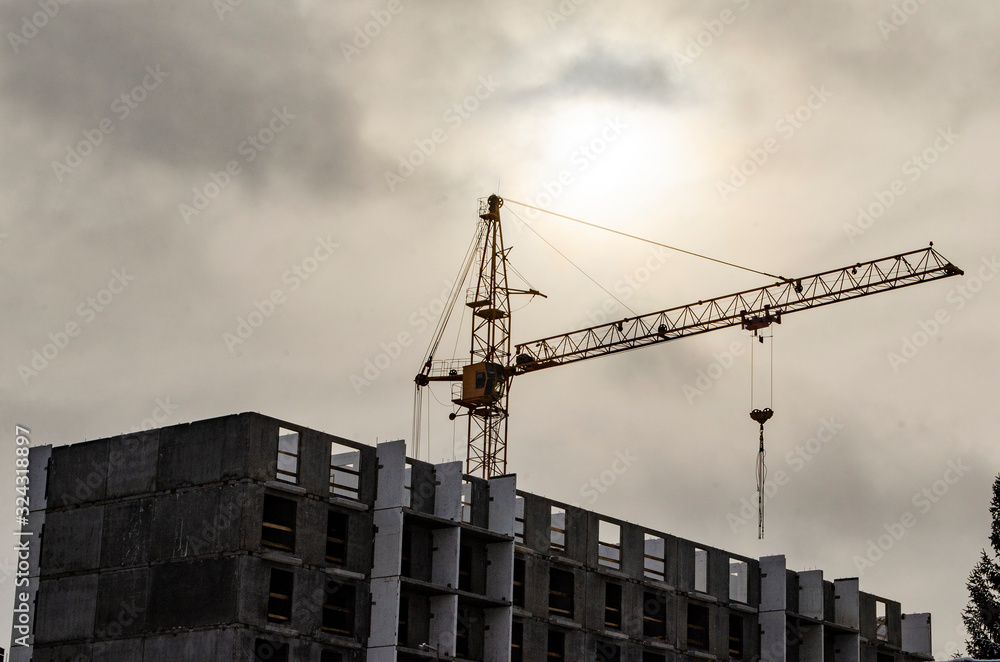 overhead tower crane in cloudy weather