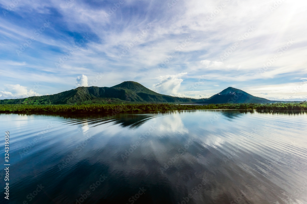 Oceania, Papua New Guinea, Island of New Britain, View of volcanoes Tavurvur and Vulcan across sea Oceania, Papua New Guinea, Island of New Britain, View of volcanoes Tavurvur and Vulcan across sea
