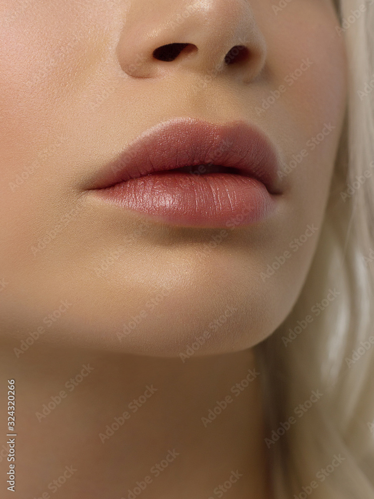 Foto Stock Closeup plump Lips. Lip Care, Augmentation, Fillers. Macro photo  with Face detail. Natural shape with perfect contour. Close-up perfect  natural lip makeup beautiful female mouth. Plump sexy full lips