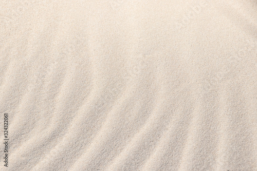 Light, beige, sand, wave, reflect, shadow. Beautiful patterns in a sand of dune like ruffle in water. Close-up. Summer concept.