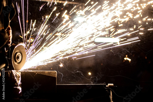 The process of stripping metal using an abrasive wheel on a grinding machine. Sparking is hazardous to the eyes.
