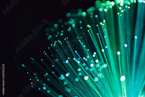 Fiber optic abstract neon lights colorful background. Close up view with bokeh. Glowing optical fibers. Abstract image with copy space.