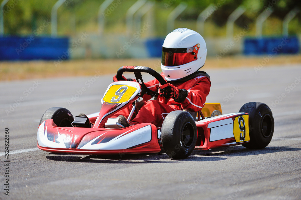 Young go cart racer on circuit - obrazy, fototapety, plakaty 