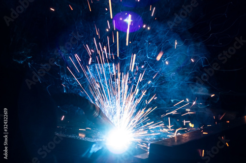 The process of welding metal in the dark with the formation of a large amount of smoke and sparks.