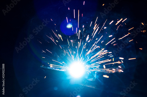 The process of welding metal in the dark with the formation of a large amount of smoke and sparks.