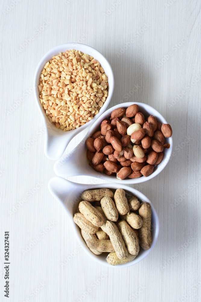 Dried peanuts (Arachis hypogaea) peanuts in shells, whole and chopped in containers Dried peanuts (Arachis hypogaea) peanuts in shells, whole and chopped in containers