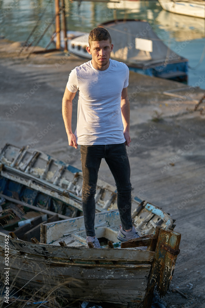 Gola de Pujphoto shoot,A young men with a casual air over an old boatol