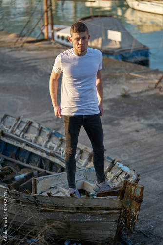 Gola de Pujphoto shoot,A young men with a casual air over an old boatol